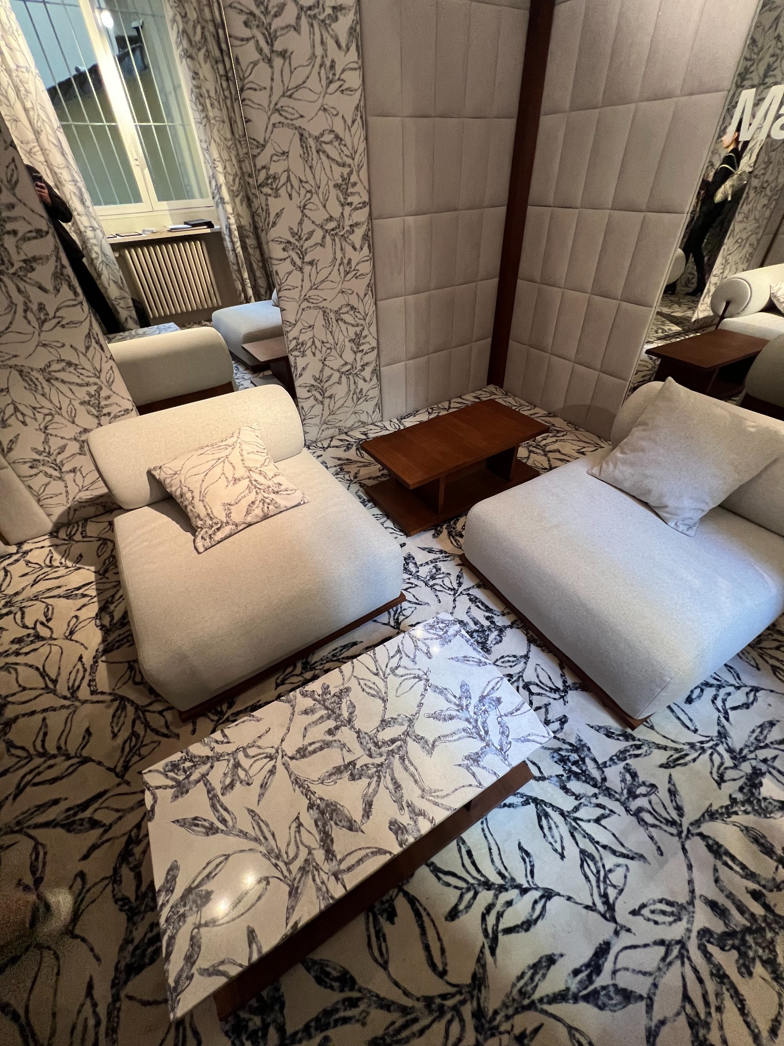 A printed coffee-table graphic seen alongside coordinated patterns in an interior setting.