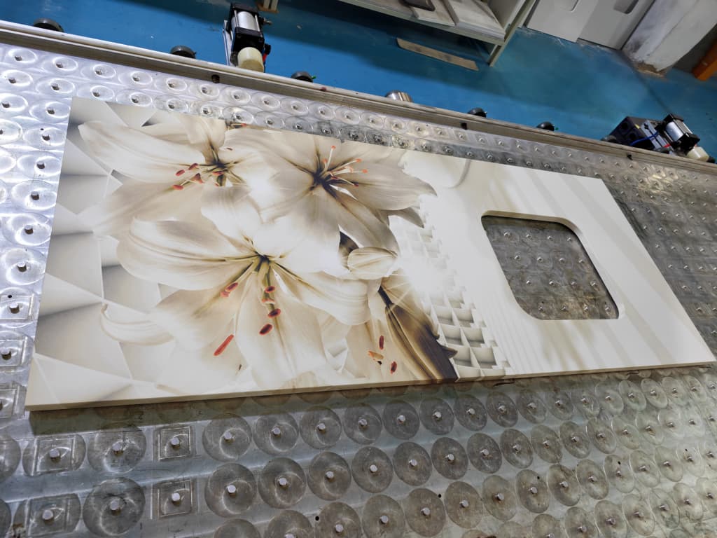 A worked top with a large floral graphic and a rounded rectangular cut-out.