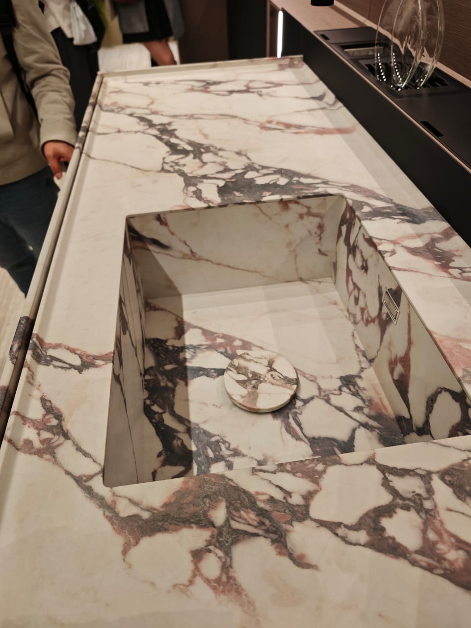 Veined fabricated surface with an integrated sink and printed edge detail.