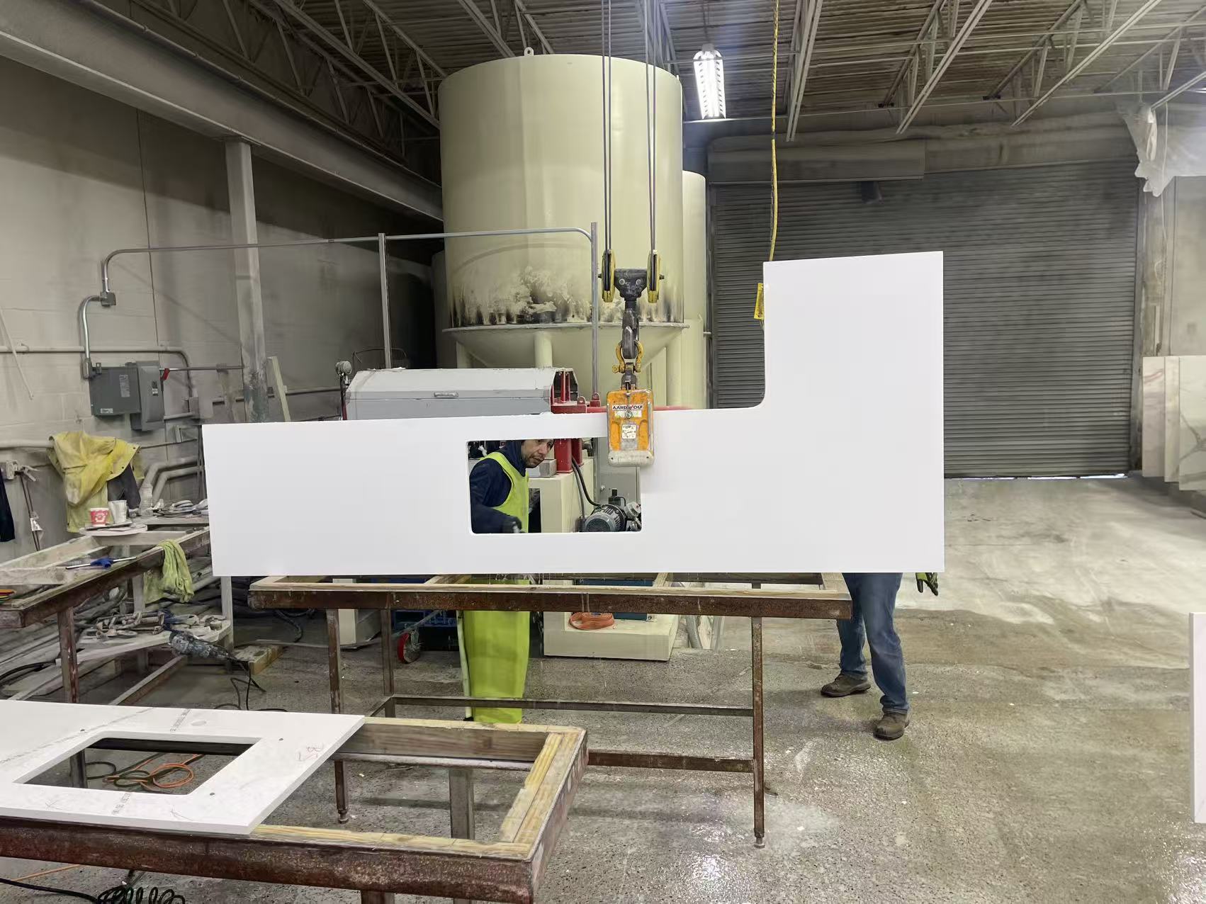 White fabricated countertop with a sink cut-out being handled in the workshop before printing.